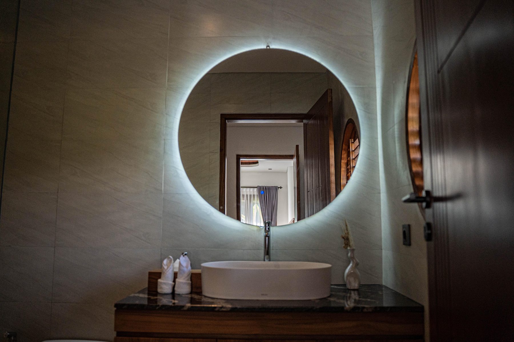 Bathroom vanity with round backlit mirror