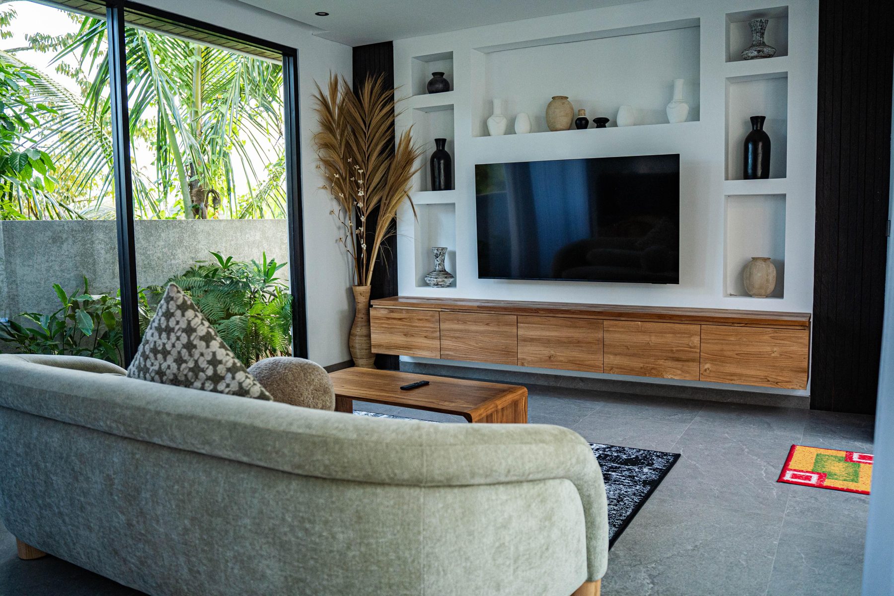 Living room with teak media unit and garden view
